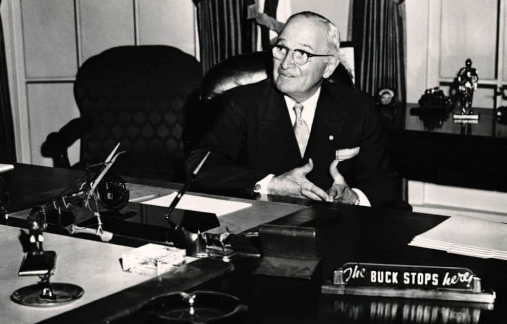 A 'the buck stops here' style nameplate on a desk